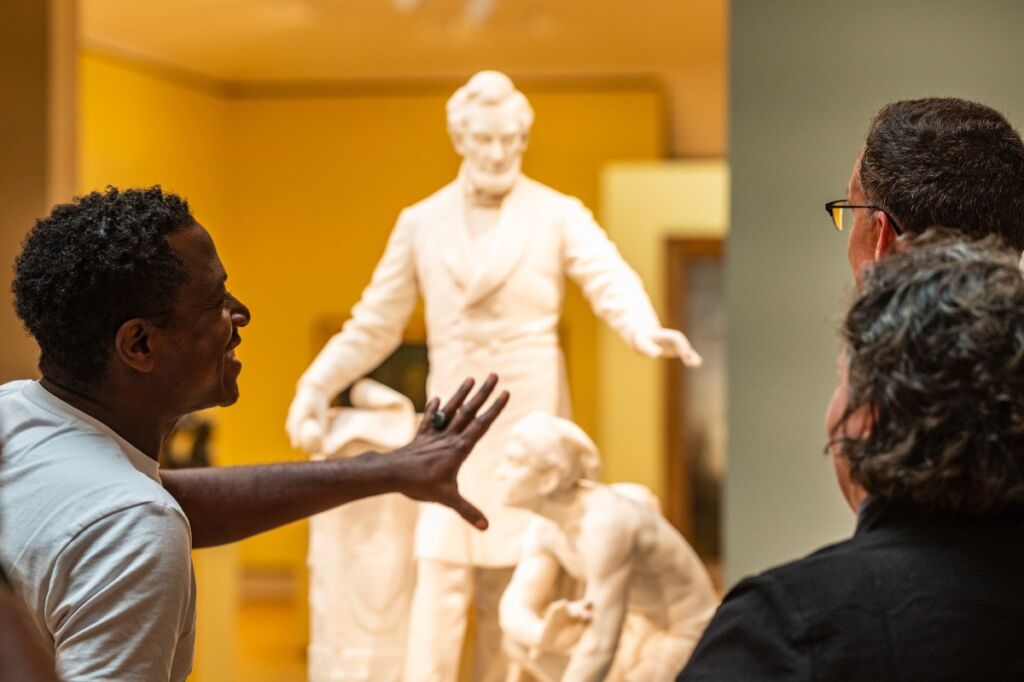 Sanford Biggers discusses the statue with others at the Chazen Museum